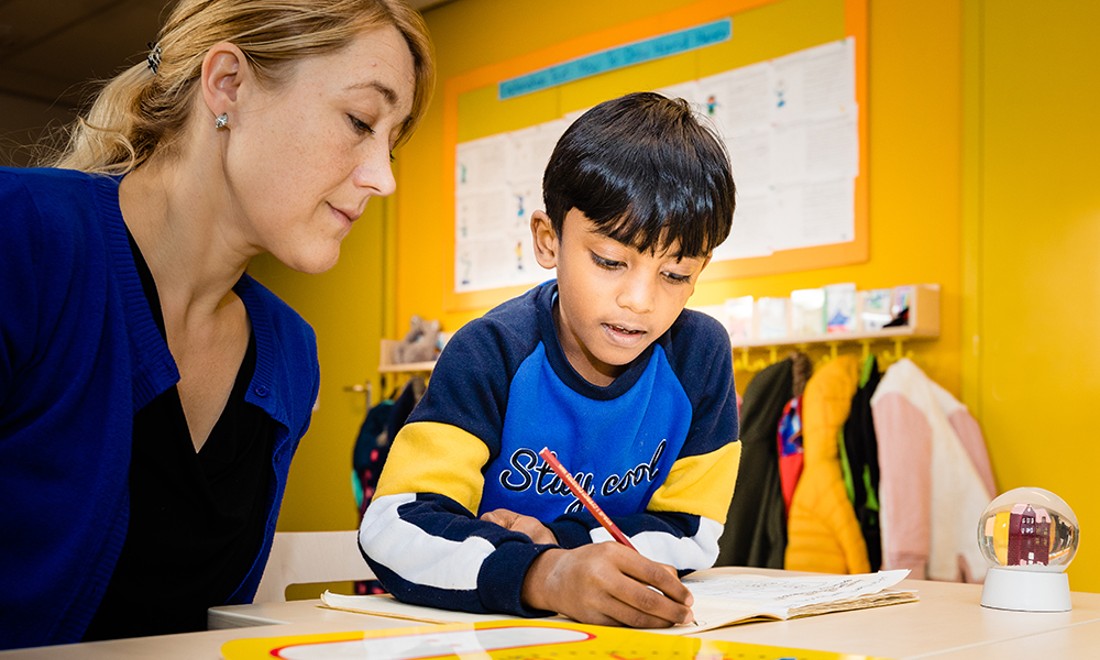 teacher and child learning Optimist International School