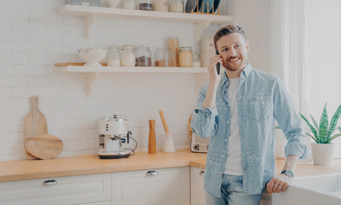 Man on a phone call in the kitchen