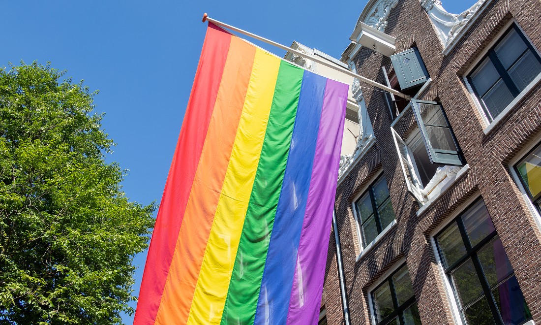 Pride Amsterdam rainbow flag canal house