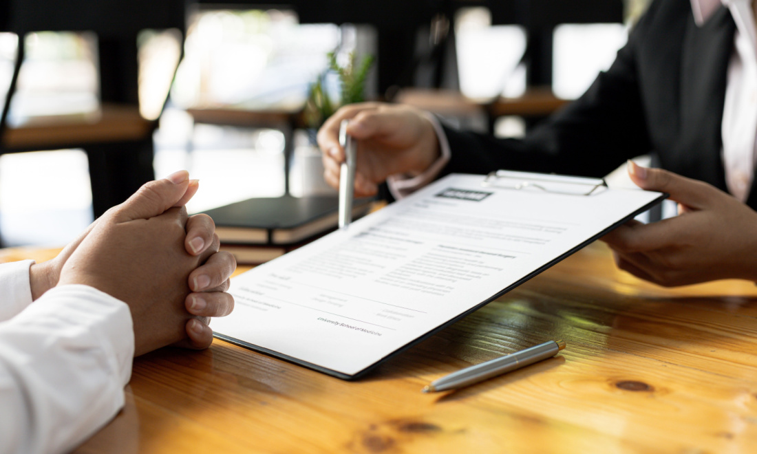 recruiter showing paper to job applicant