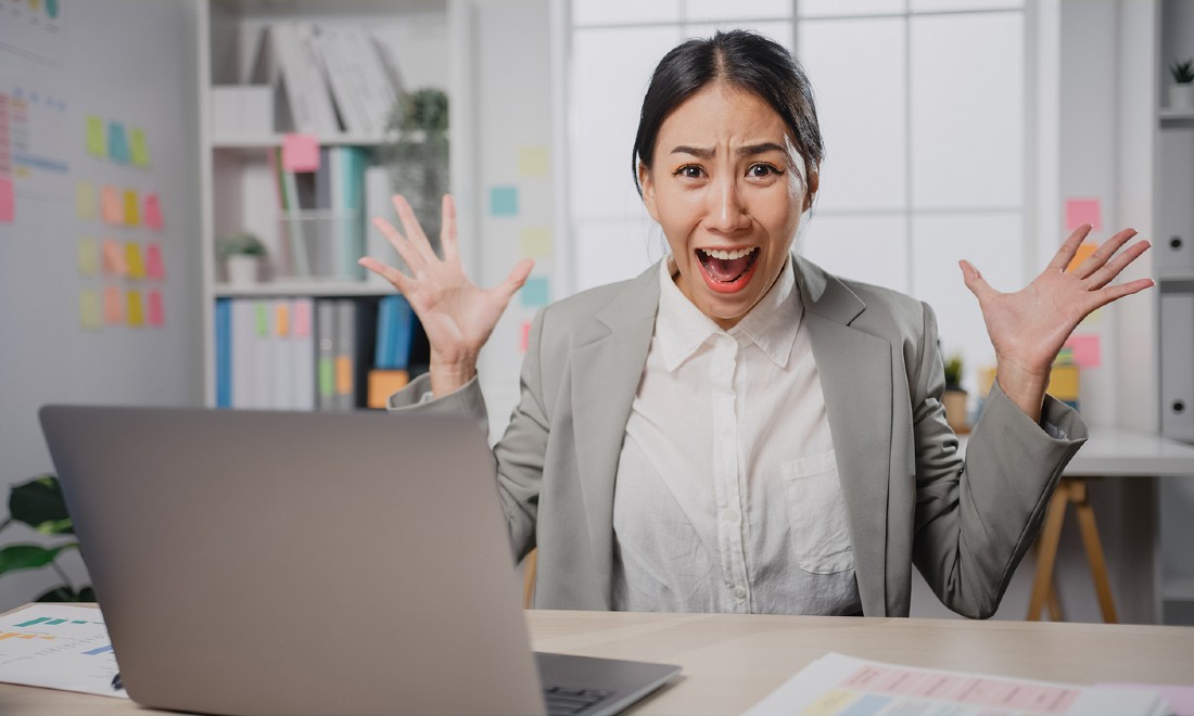 woman screaming in frustration at work - watch out for these red flags at your workplace