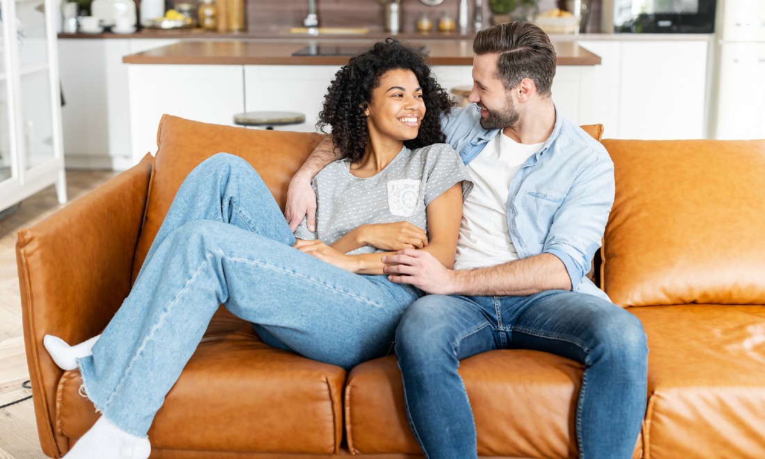 couple on sofa looking lovingly at each other