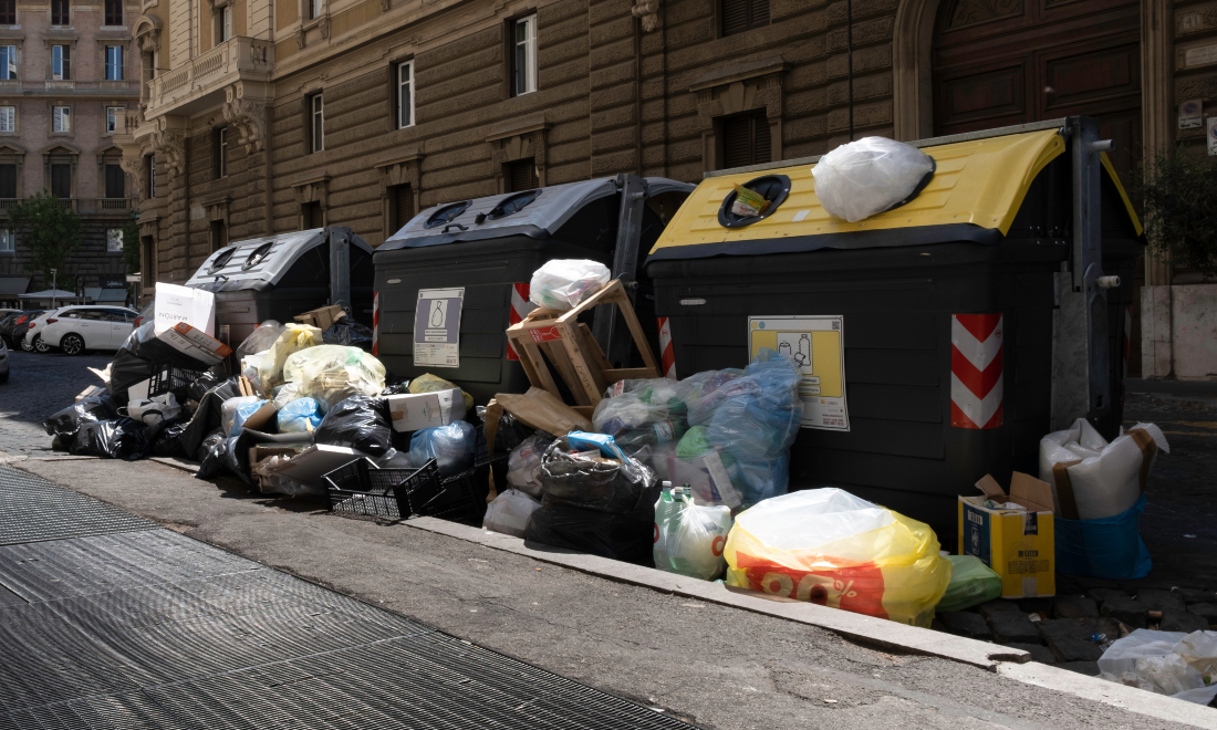 Rubbish piled up outside bins on the streets of Rome, Italy