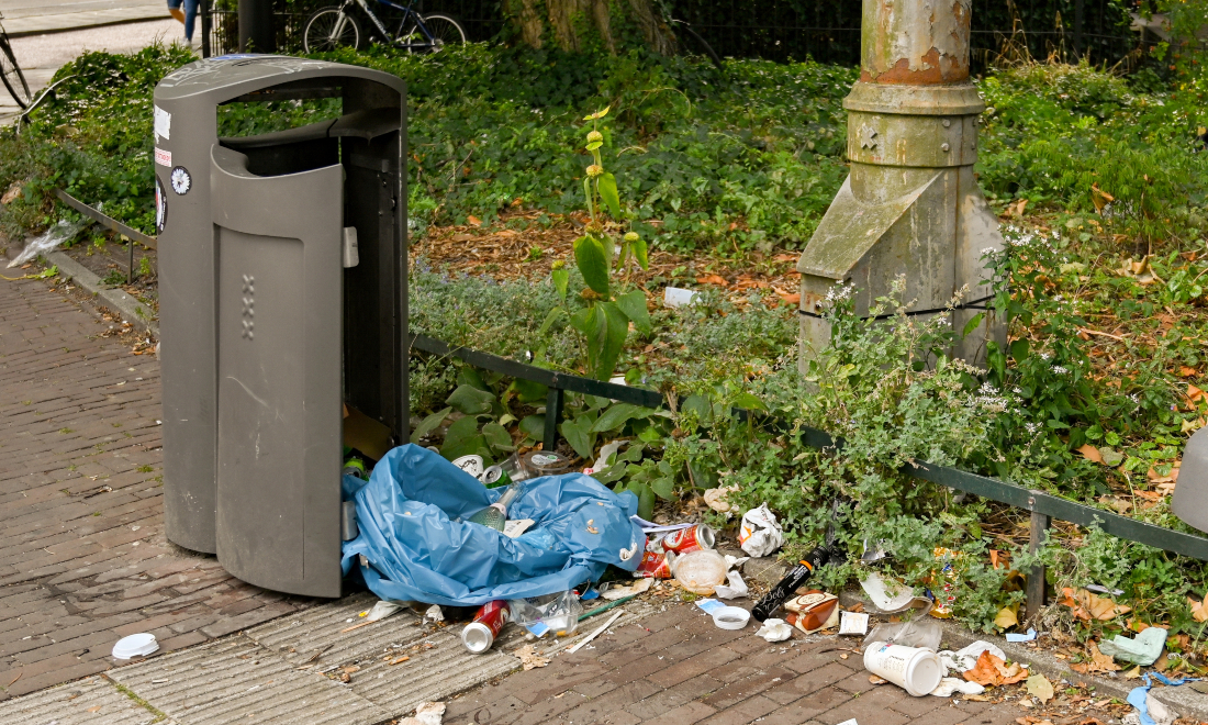 Broken bin and rubbish on the streets of Amsterdam, the Netherlands