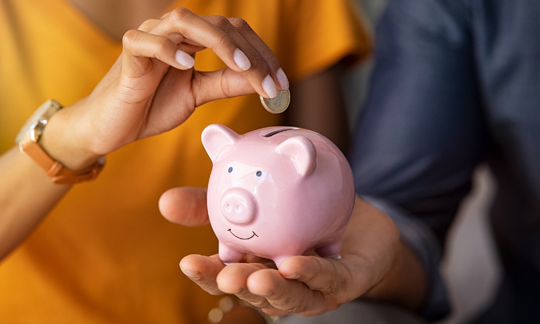 Couple saving money piggy bank the Netherlands