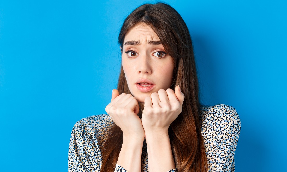 frightened woman blue background