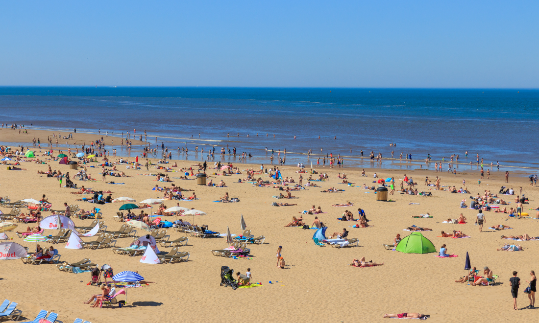 People sunbathing on Scheveningen beach on a hot summer's day