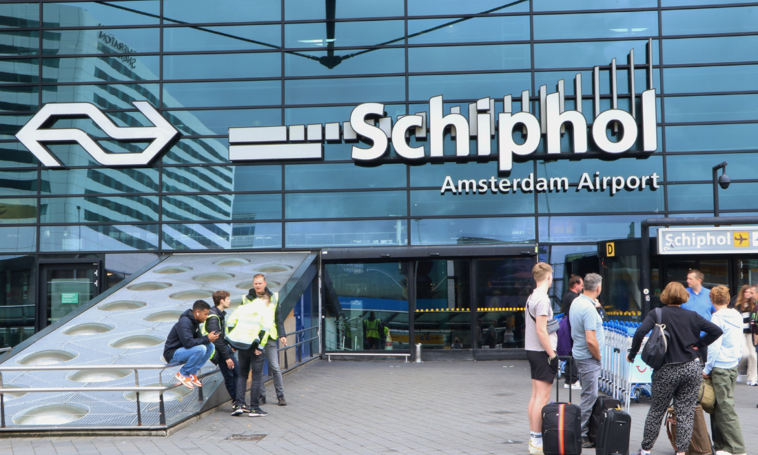 Travellers outside Schiphol Airport in Amsterdam, the Netherlands