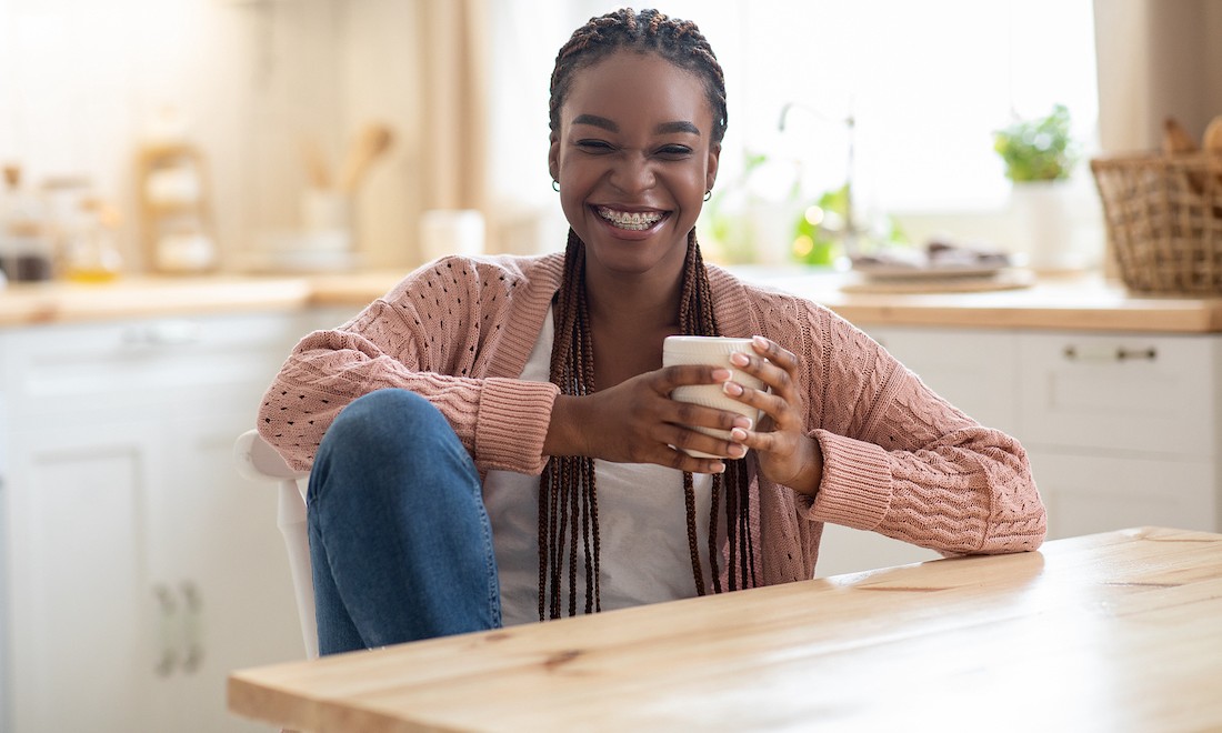 Smiling girl sitting in kitchen