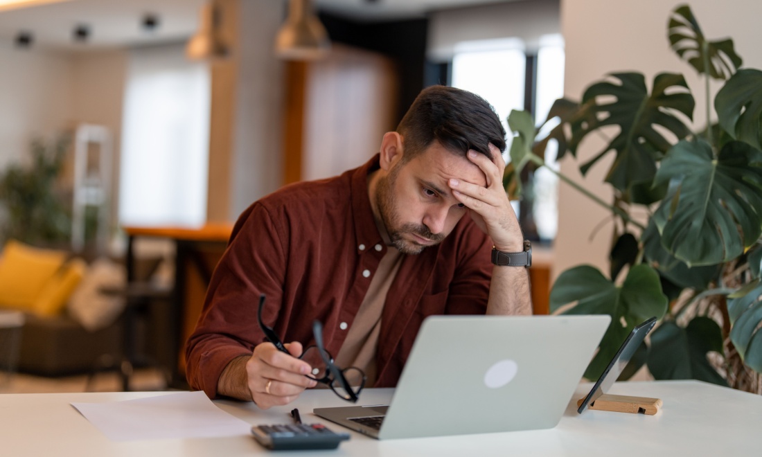 stressed man using laptop