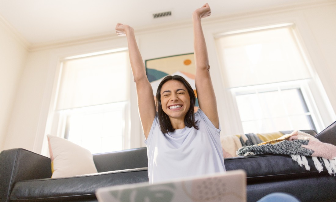 Happy person behind laptop - ETS Global GRE General Test