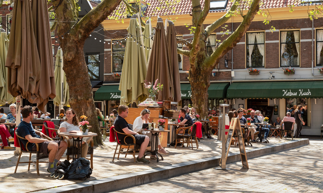 People at cafe terrace enjoying sunny Dutch weather