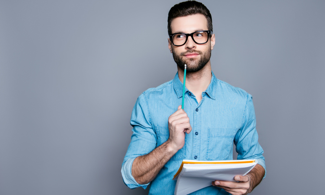 man holding pencil thinking