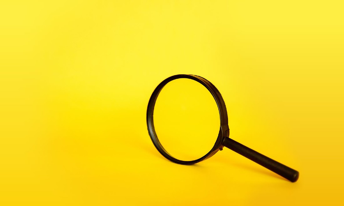 a magnifying glass on yellow background