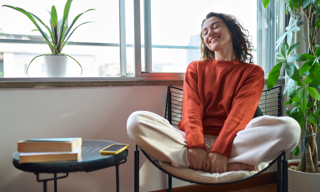 Therapy with Olivia woman smiling and sitting at home