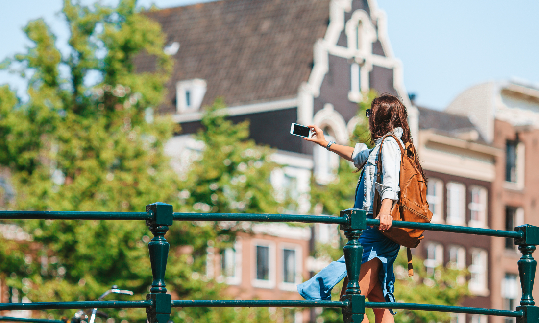 Tourist visiting Amsterdam canals