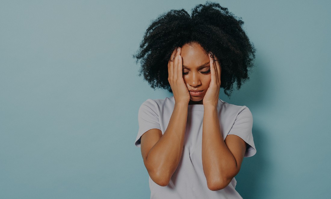 woman with hands on head, trauma