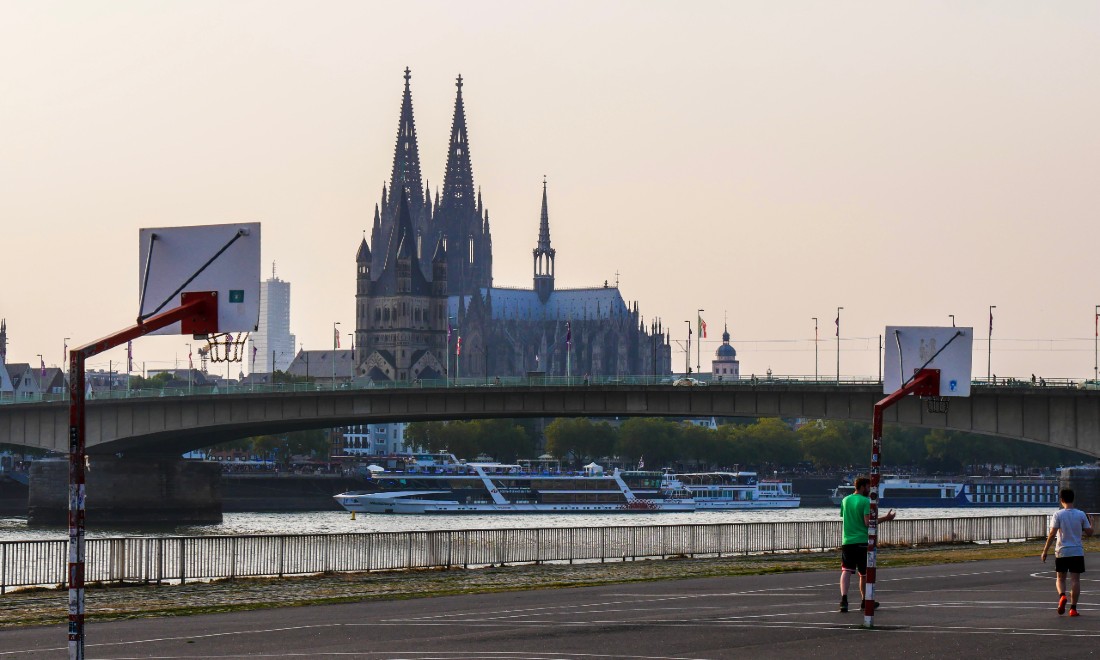 cologne cathedral across the river from a basketball court