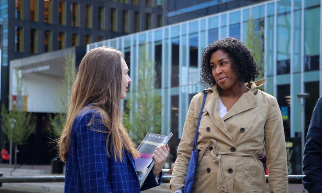 UvA Talen women smiling outside