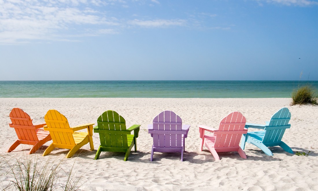 beach with multicoloured beach chairs