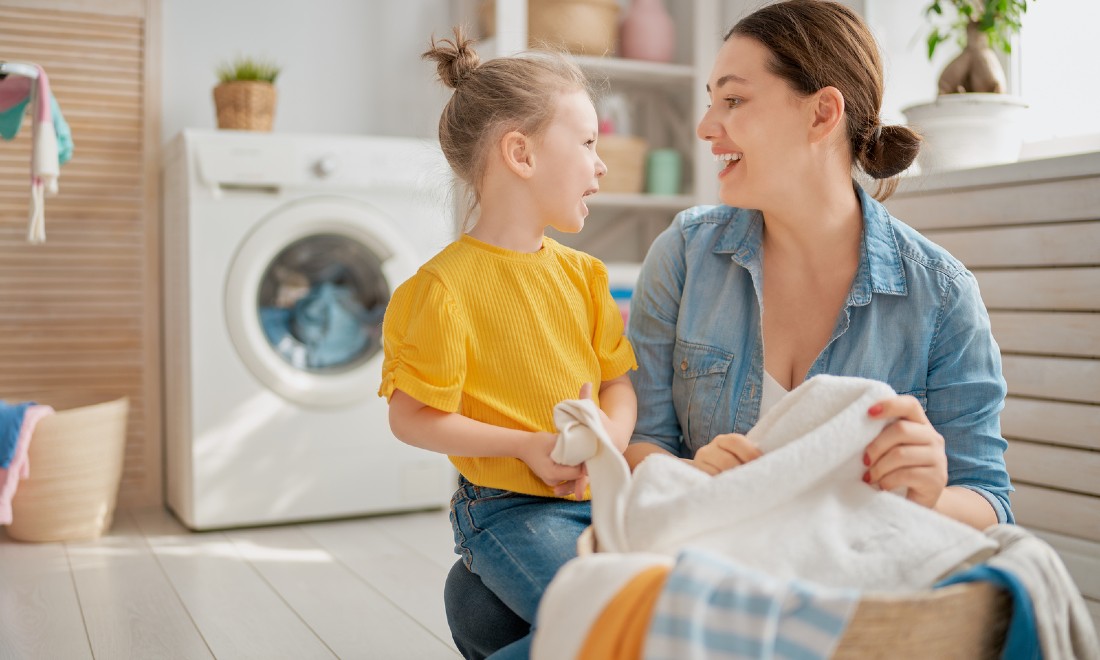 Woman and daughter doing laundry