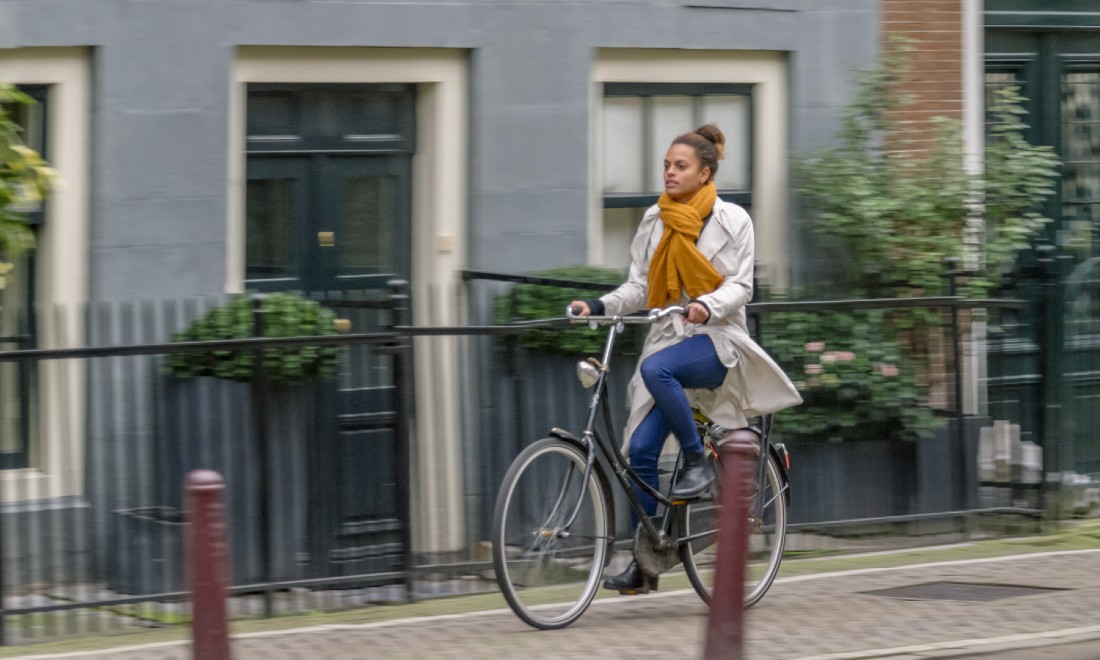 woman biking streets amsterdam