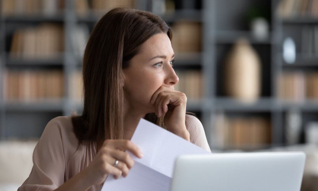 worried woman holding paper