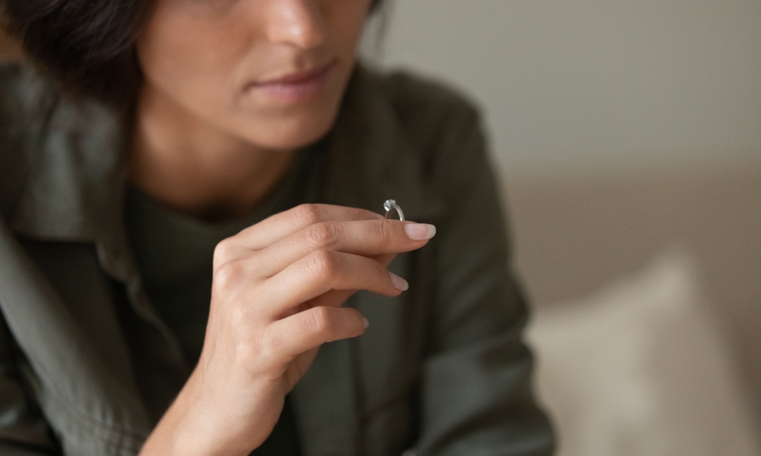 woman holding wedding ring