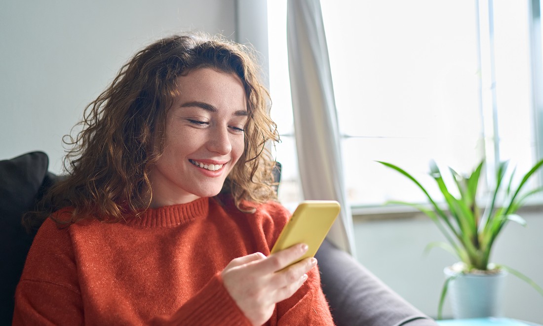 woman smiling at phone - Lyca Mobile