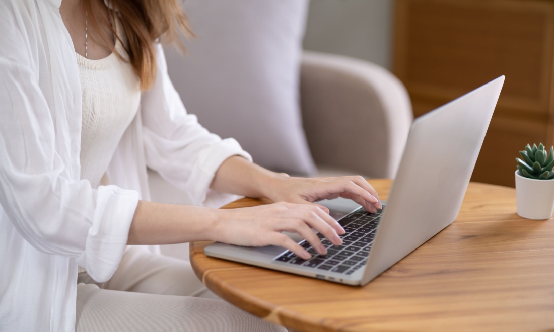 woman typing on laptop at home