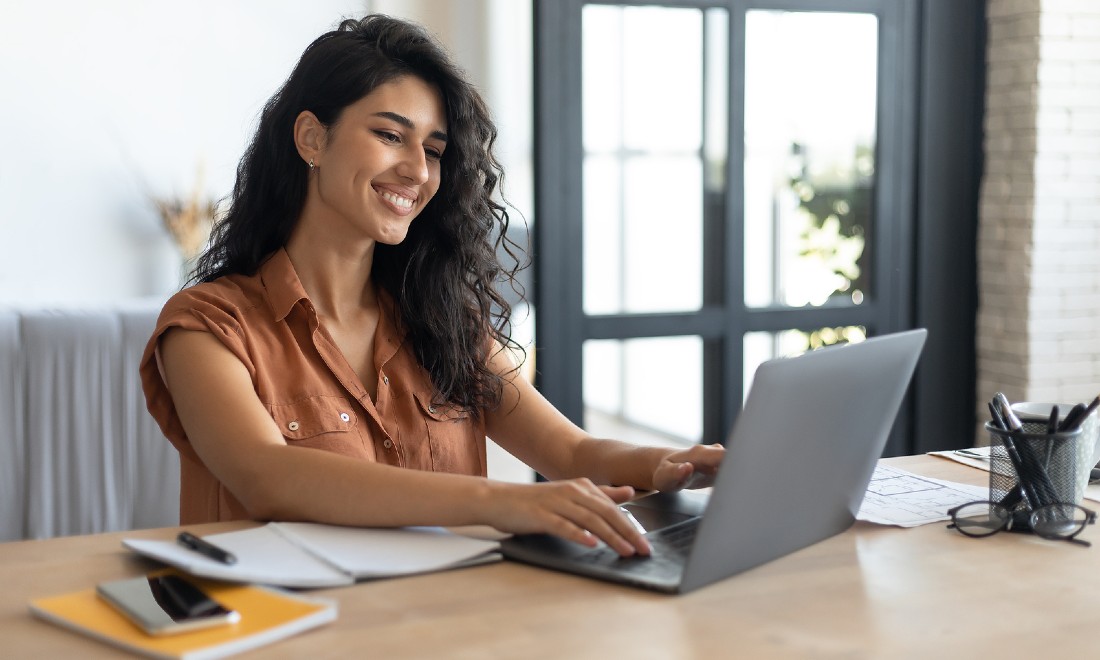 woman on laptop working on her marketing