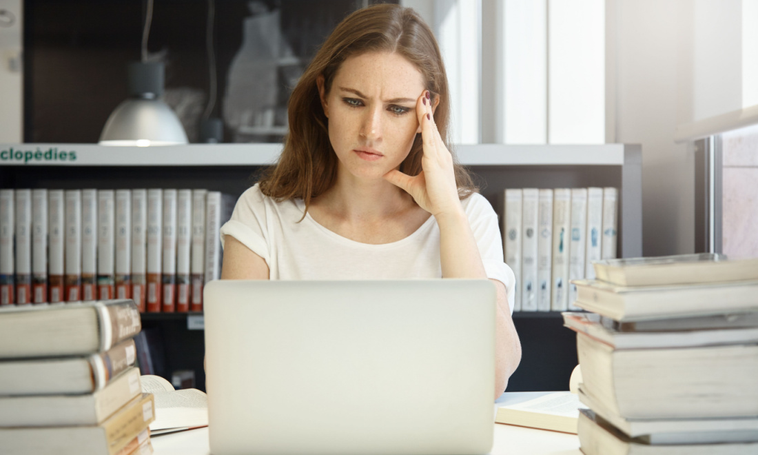 woman focusing on laptop screen