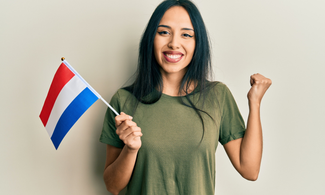 woman smiling holding dutch flag